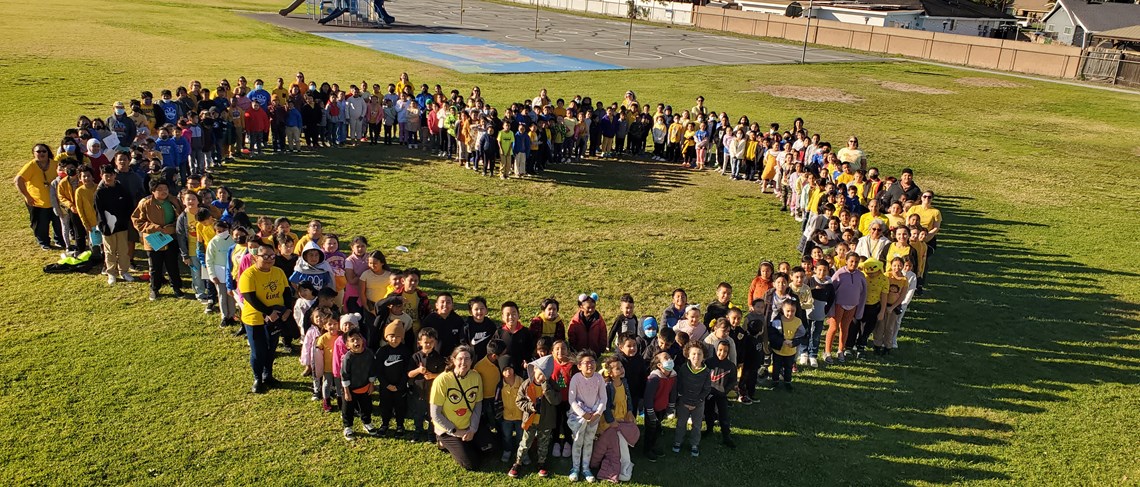 Students standing in a heart shape