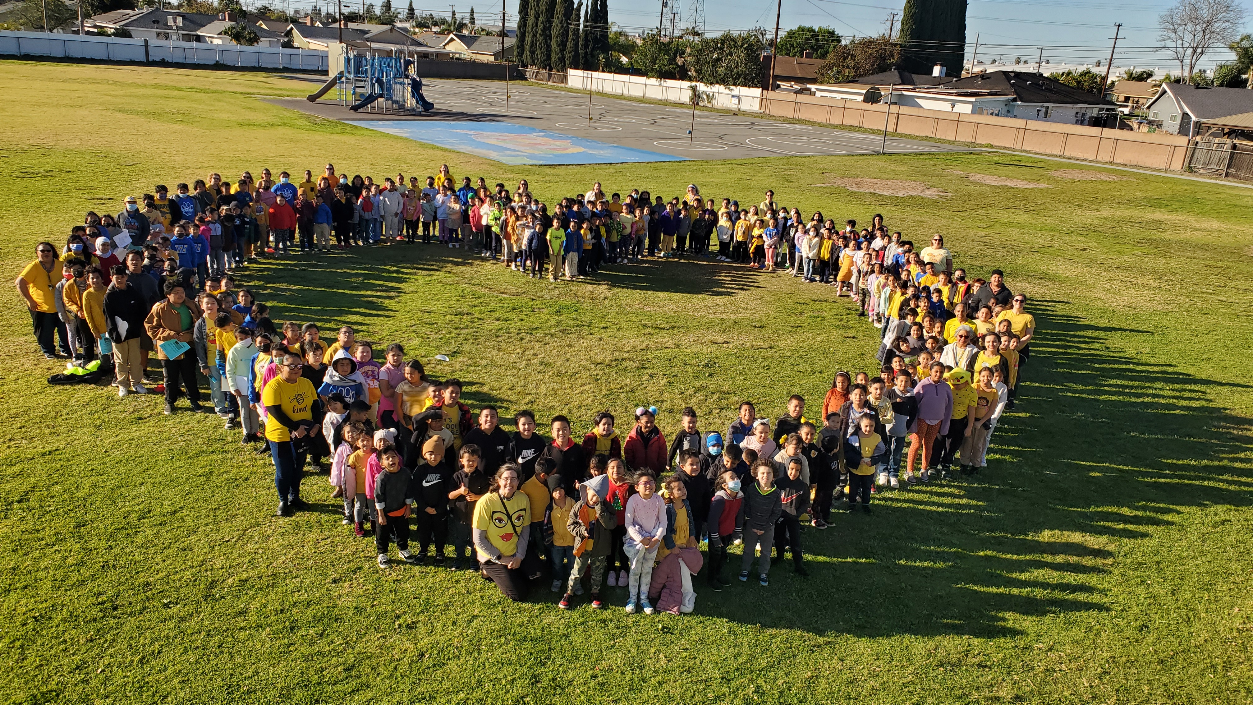 Students standing in a heart shape for Kindness Week